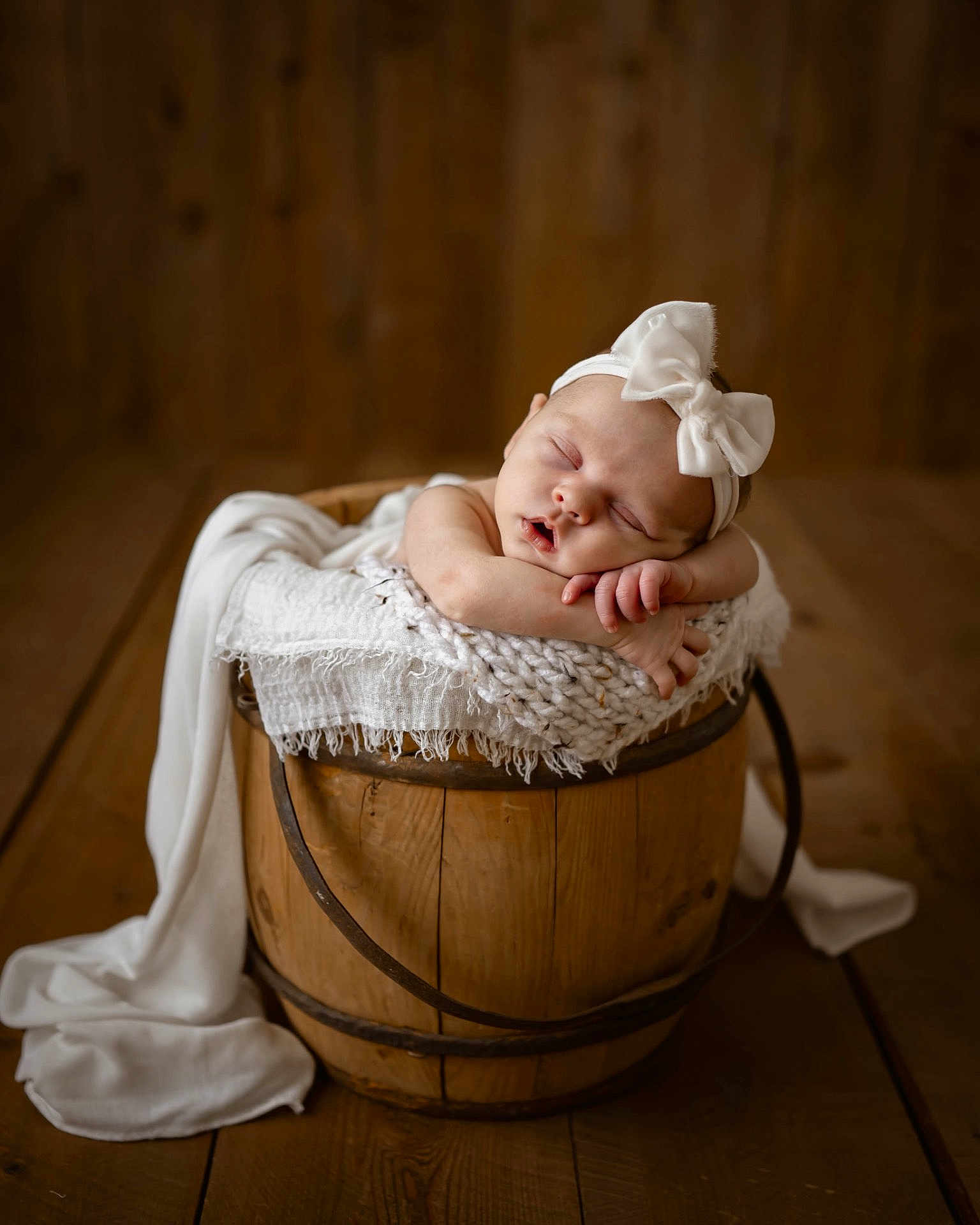 Bridgette joined the competition — help win amazing prizes! baby, sleeping, headband, bow, wooden_bucket, blanket, cozy, infant, peaceful, portrait, wooden_floor, soft_texture, cute, resting, newborn, child, indoor, warm_lighting, relaxation, adorable