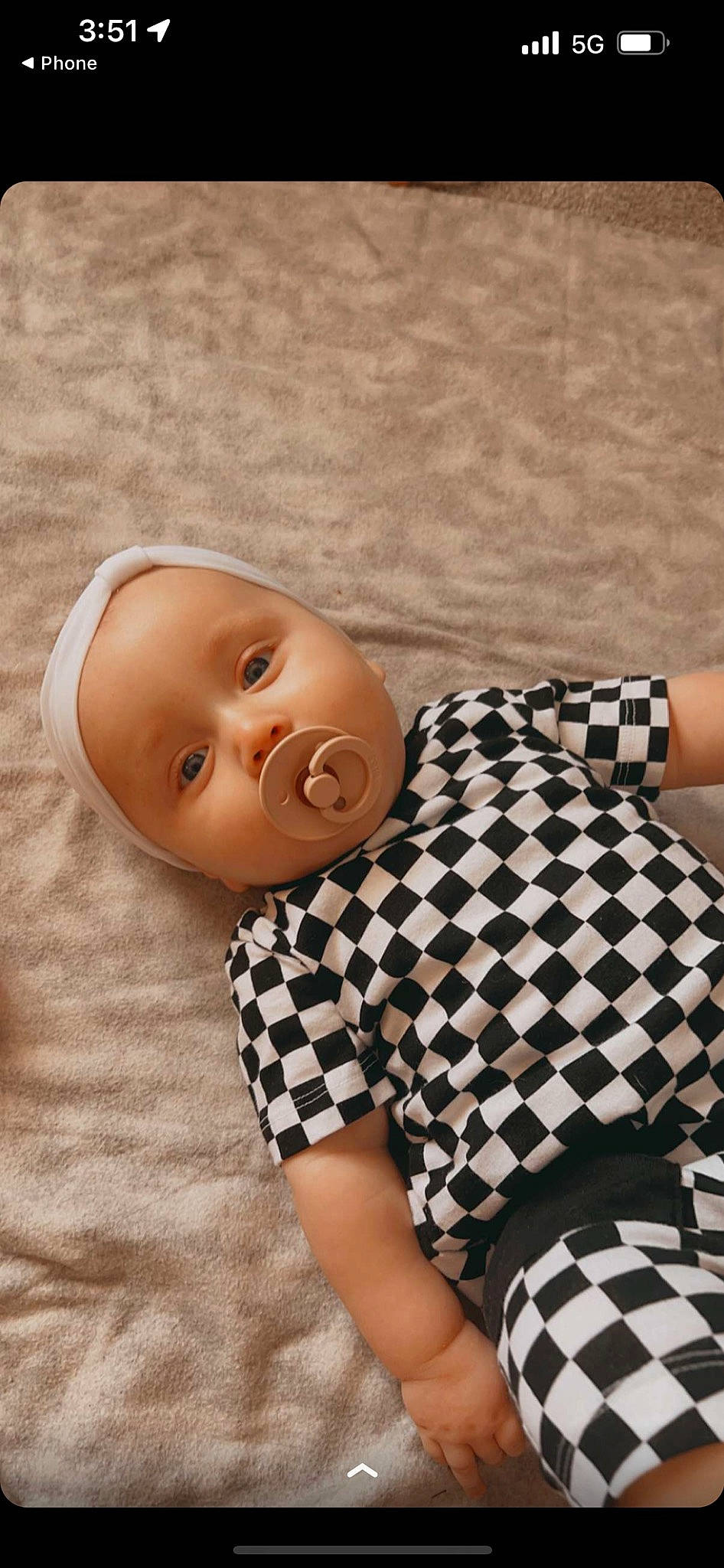 Eliza is registered to the contest to win money with this photo: baby, baby_toddler_clothing, child, close_up, collar, comfort, fashion_design, happy, linens, mammal, neck, pattern, person, plaid, sitting, skin, sleeve, thigh, toddler, vertebrate