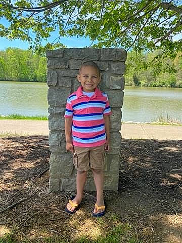 Mason is registered to the contest to win money with this photo: child, grass, joy, person, plant, play, rock, standing, stone_wall, summer, toddler, tree, vacation