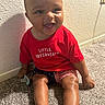 Jaylen is registered to the contest to win money with this photo: baby, infant, child, smile, happy, red_shirt, clothing, sitting, carpet, floor, indoor, footwear, blue_sandals, cute, portrait, person, skin, head, face, pacifier