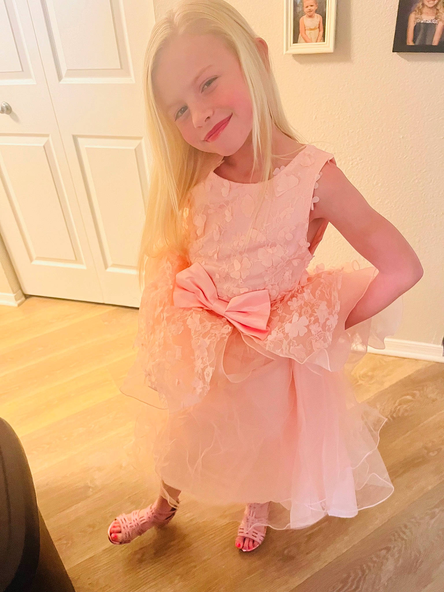 Skylar is registered to the contest to win money with this photo: baby_toddler_clothing, dress, embellishment, fashion_design, finger, floor, flooring, hand, happy, hardwood, joint, joy, knee, laminate_flooring, person, picture_frame, pink, sleeve, smile, thigh