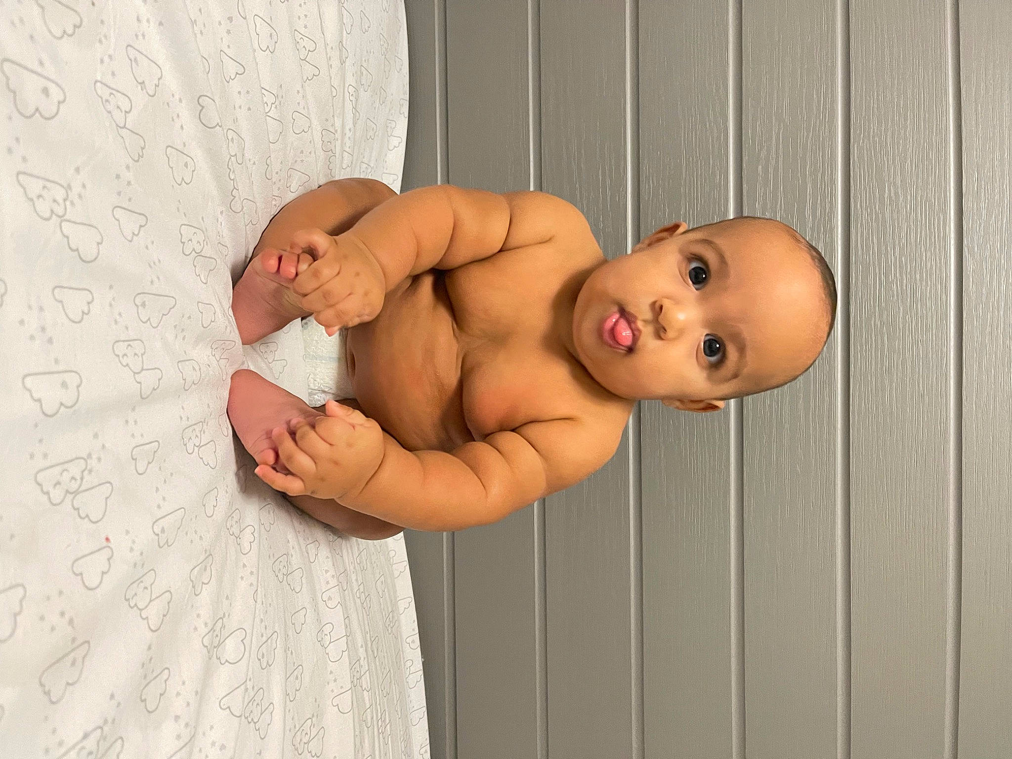 Michael joined the competition — help win amazing prizes! abdomen, baby, cheek, chest, elbow, eye, face, finger, gesture, hand, human_body, joint, leg, person, skin, stomach, toddler, trunk, wall, wood