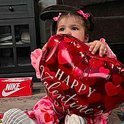 Kehlani joined the competition — help win amazing prizes! toddler, child, balloon, valentines_day, heart, pink_clothing, sitting, indoor, toy, hair_bows, curious, floor, shoe_box, nike, home_interior, carpet, furniture, cute, playful, holiday