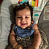 baby, smiling, child, infant, cute, pigtails, blue_dress, leopard_print, seat, baby_seat, patterned, colorful, happy, portrait, indoor, person, face, young_child, joyful, playful