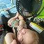 River is registered to the contest to win money with this photo: baby, car_seat, stuffed_toy, blanket, fan, child, infant, smiling, hand, toy, seatbelt, clothing, indoor, safety_warning, cute, face, person, reaching, light, hair