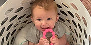 River joined the competition — help win amazing prizes! baby, child, laundry_basket, toy, pink, indoor, floor, rug, smiling, happy, seated, clothing, playful, beads, cute, infant, home, person, colorful, candid