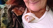 Qweenie joined the competition — help win amazing prizes! woman, kitten, cat, face, smile, shirt, clothing, jacket, camouflage, hair, indoor, closeup, pet, animal, cozy, resting, cute, feline, comfort, cuddle