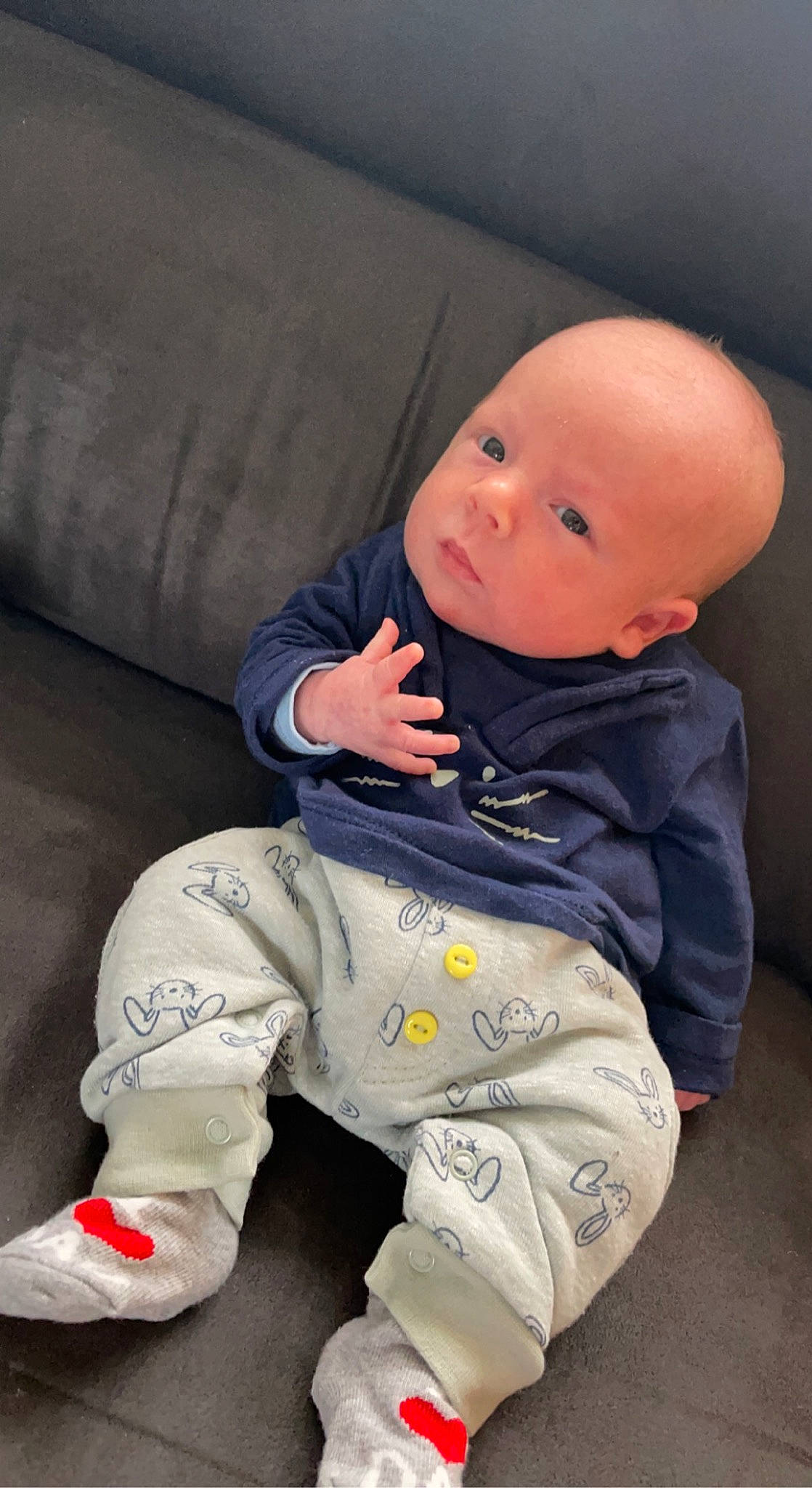 Raphaël participe au concours pour gagner de l'argent avec cette photo : baby, baby_toddler_clothing, cheek, child, comfort, couch, facial_expression, finger, flooring, fun, head, human_body, mouth, nose, outerwear, person, skin, sleeve, sneakers, textile
