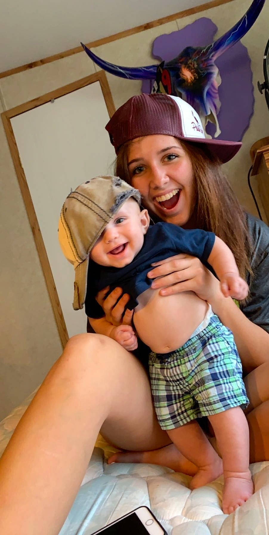 Jaxson is registered to the contest to win money with this photo: daughter, finger, joy, leg, pattern, person, plaid, thigh