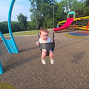 Mila is registered to the contest to win money with this photo: blue_sky, casual_clothing, child, daytime, fun, grass, happy, nature, outdoor, park, play, playground, recreation, slide, sneakers, summer, sunlight, swing, toddler, trees