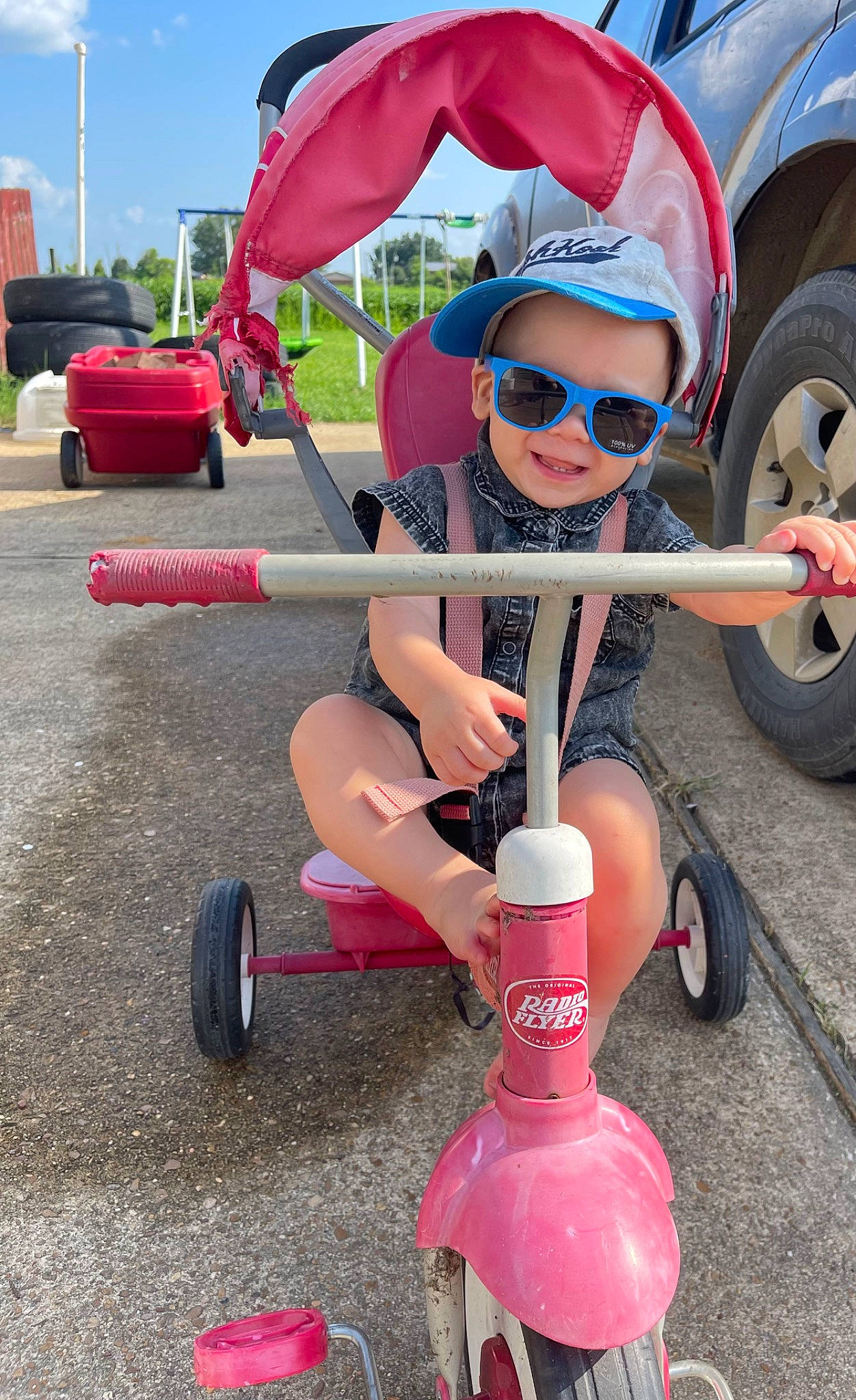 Jaxon joined the competition — help win amazing prizes! auto_part, automotive_exterior, automotive_tire, automotive_wheel_system, car, electric_blue, eyewear, goggles, hat, human_leg, joy, person, red, shorts, sky, smile, sunglasses, synthetic_rubber, tire, toddler