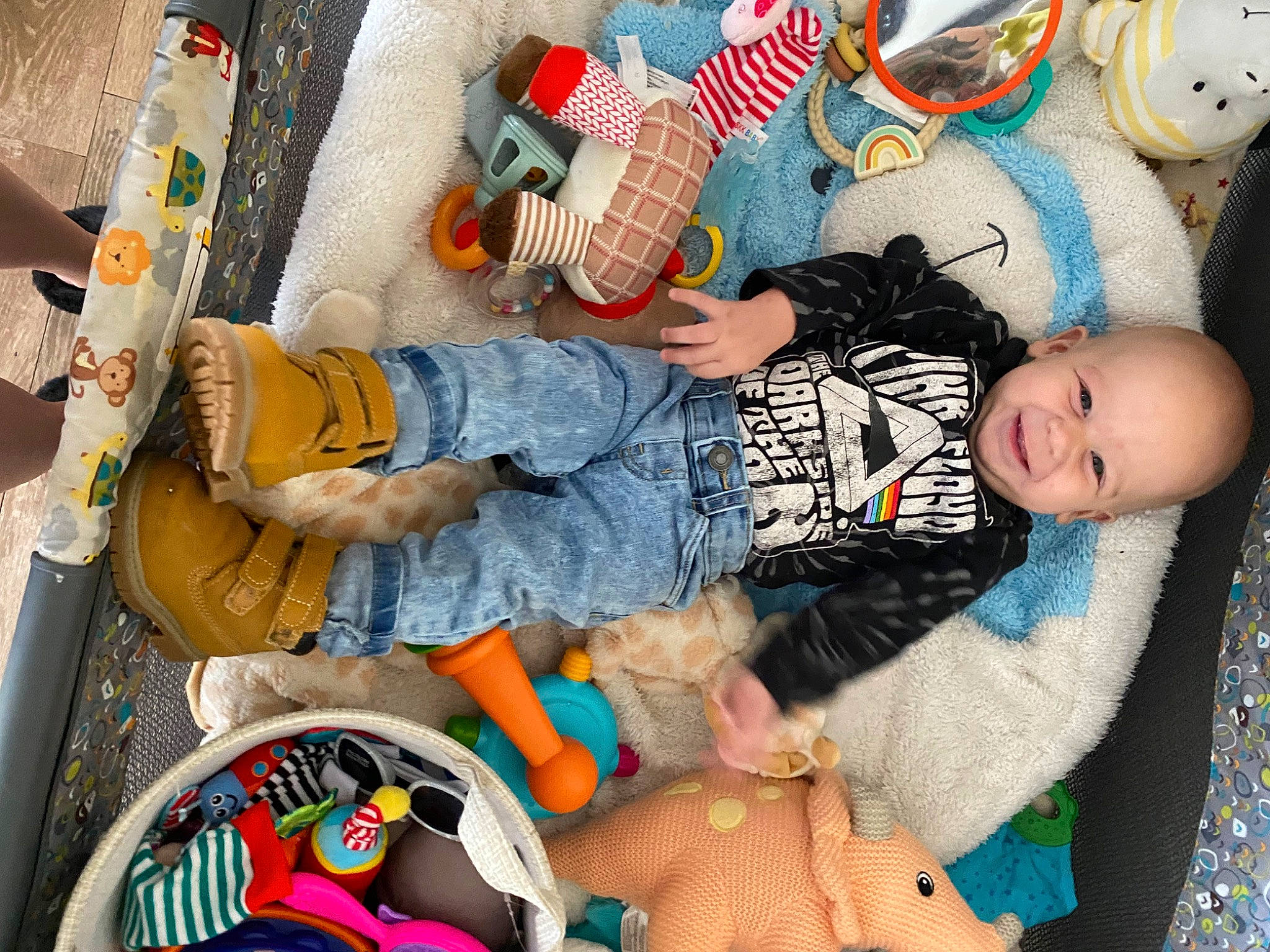 Jaxon is registered to the contest to win money with this photo: baby, baby_products, baby_toddler_clothing, baby_toys, blue, child, comfort, doll, fun, happy, human_body, joy, leg, orange, person, room, sitting, stuffed_toy, textile, thigh