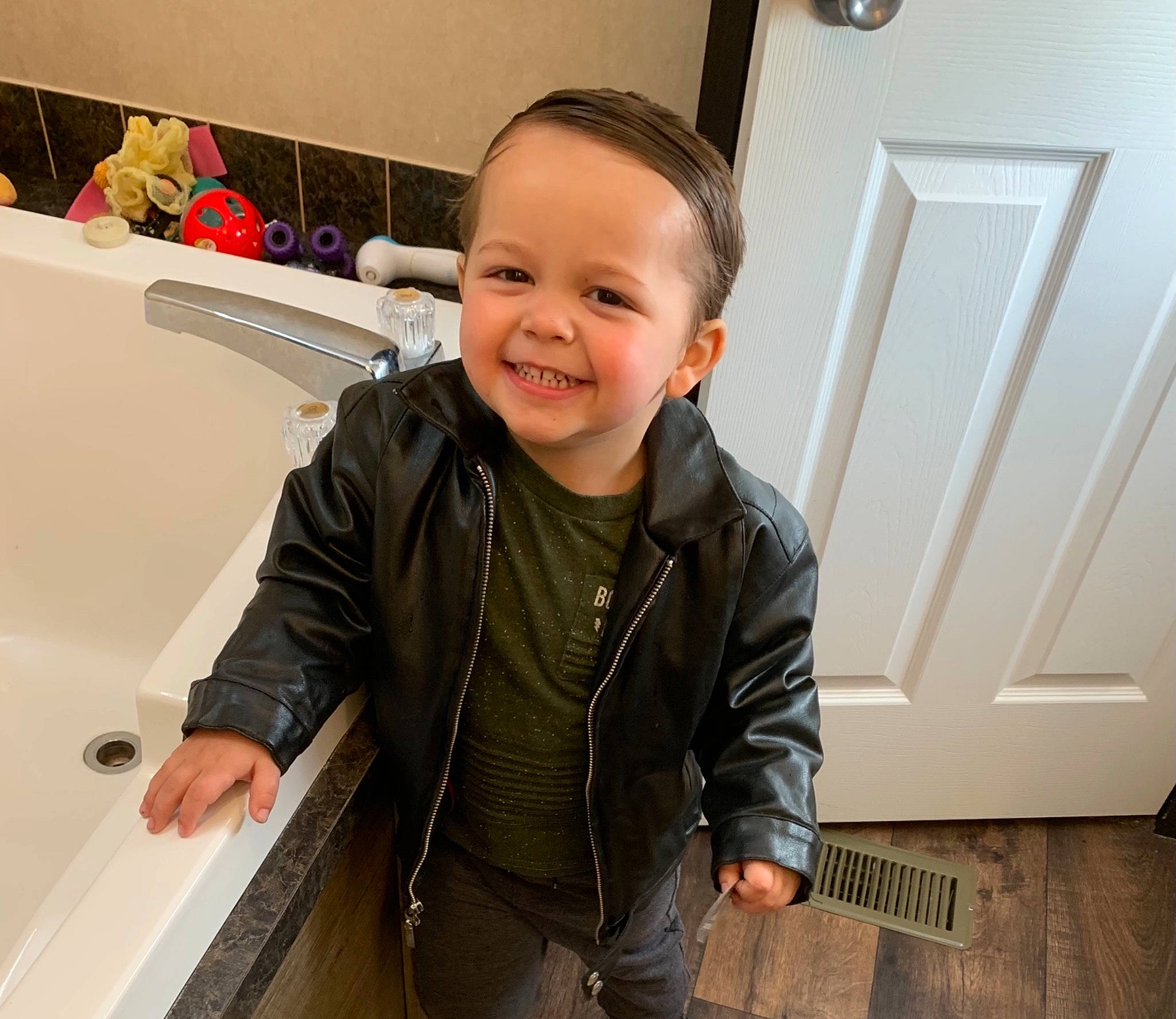 Keyten joined the competition — help win amazing prizes! automotive_design, child, denim, door, floor, flooring, fun, happy, hardwood, jacket, joy, person, personal_protective_equipment, room, skin, sleeve, smile, standing, t_shirt, toddler