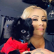 Bear joined the competition — help win amazing prizes! black_dog, blonde_hair, bracelet, ceiling_fan, curtains, disco_ball, dog, face, holding, indoor, living_room, portrait, puppy, red_sweater, selfie, smartwatch, smile, sparkle_effect, tattoo, woman