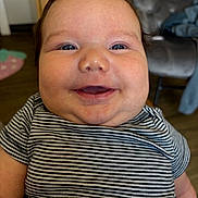 Adalynn joined the competition — help win amazing prizes! baby, smiling, face, chubby_cheeks, striped_shirt, indoor, child, happy, close_up, person, cute, young_child, head, expression, portrait, seated, furniture, floor, clothing, skin