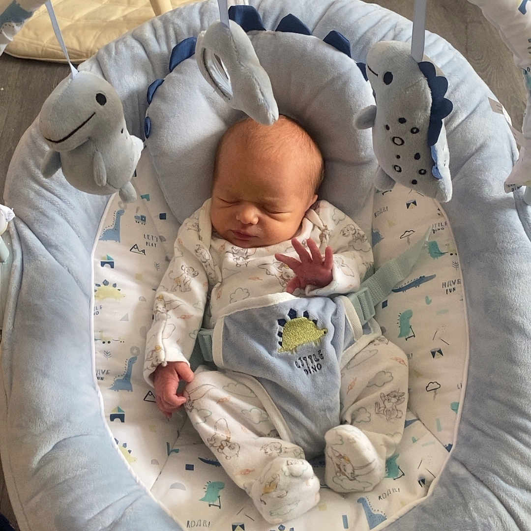 Elijah joined the competition — help win amazing prizes! baby, bed, blanket, cradle, crib, cushion, face, furniture, head, homedecor, infantbed, machine, newborn, person, photography, portrait, quilt, sleeping, toy, wheel