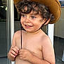 Nael participe au concours pour gagner de l'argent avec cette photo : boy, child, chin_strap, cowboy_hat, curly_hair, door, eyes, face, glass_door, hands, happy, hat, indoors, mouth, person, shirtless, skin, smiling, standing, toddler