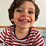 casual_clothing, cheerful, child, childhood, close_up, cute, expression, eyelashes, face, hair, happy, indoors, joyful, person, portrait, skin, smiling, striped_shirt, toddler, young