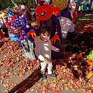 Bryan Matheus joined the competition — help win amazing prizes! child, toddler, hoodie, autumn_leaves, halloween, inflatable_decorations, pumpkin_head, ghost, skeleton, clown, purple_creature, grave_marker, outdoor, fall, costume, holiday, decoration, daylight, person, festive
