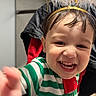 toddler, child, smiling, face, striped_clothing, green, white, red, indoor, happy, headband, halo, baby, portrait, cute, person, young_child, closeup, expression, joy