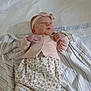 Serenity is registered to the contest to win money with this photo: baby, infant, headband, pink_clothing, floral_pattern, blanket, striped_blanket, lying_down, cute, newborn, small_hands, soft_fabric, indoors, child, portrait, sleepwear, adorable, headwear, resting, young_child
