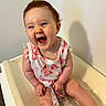 Delilah joined the competition — help win amazing prizes! baby, child, smiling, laughing, sitting, indoor, changing_table, clothing, butterfly_pattern, person, infant, happy, cute, skin, face, head, short_hair, colorful, striped, toy
