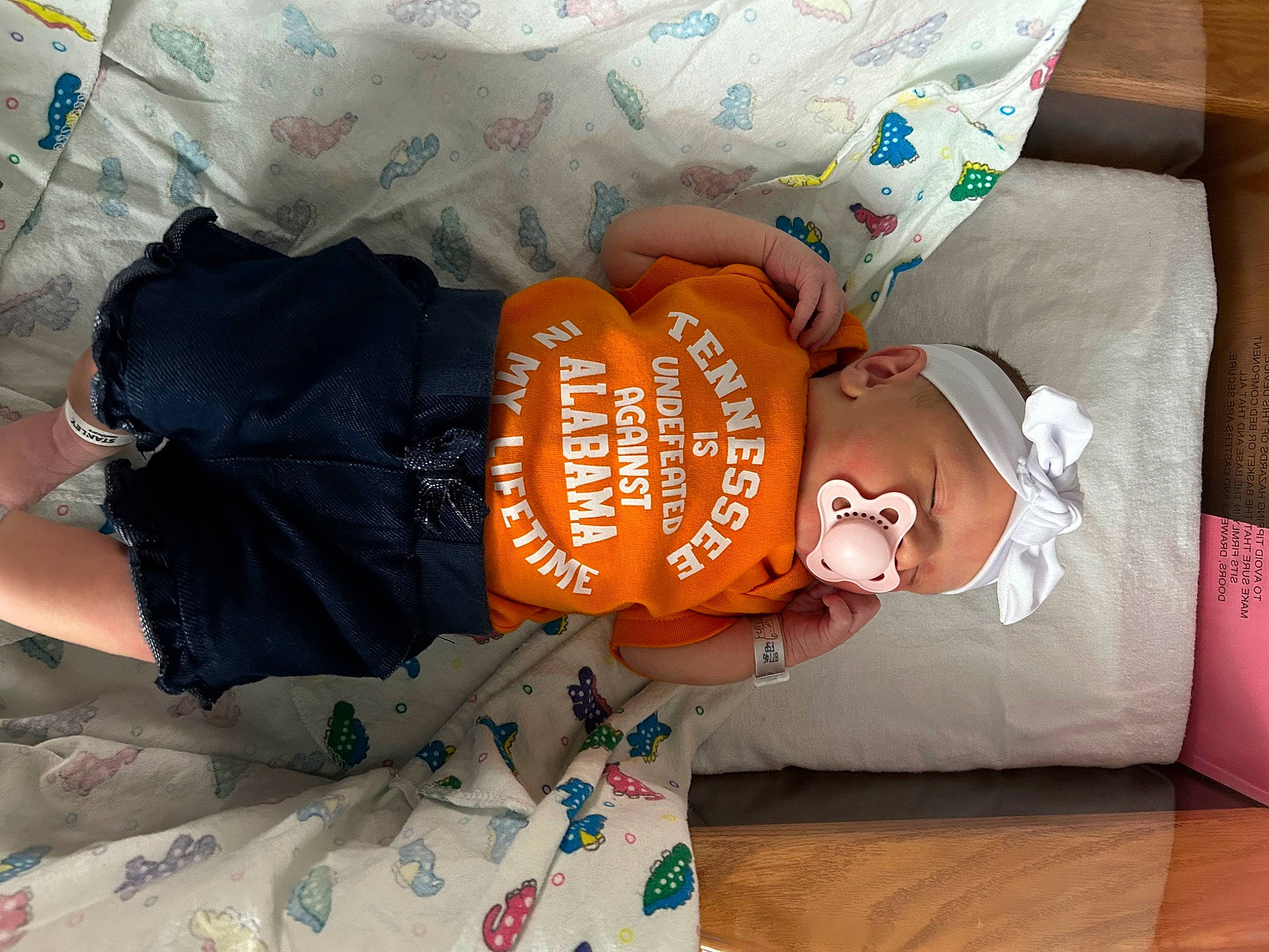 Alexandria is registered to the contest to win money with this photo: baby, baby_toddler_clothing, bedding, bedtime, child, comfort, couch, font, hat, linens, nap, pattern, person, pillow, room, sitting, sleeve, t_shirt, textile, thigh