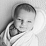 baby, newborn, infant, swaddle, blanket, pillow, portrait, closeup, smile, hand, foot, head, eyes, monochrome, black_and_white, soft_light, studio, texture, peaceful, bed