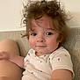 Grayson joined the competition — help win amazing prizes! toddler, child, curly_hair, rosy_cheeks, white_shirt, whale_pattern, couch, indoor, person, cute, smile, skin, arm, face, hair, young_child, seated, relaxed, light, casual