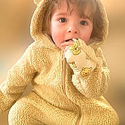 Grayson is registered to the contest to win money with this photo: child, toddler, cute, fluffy, hooded_jumpsuit, bear_ears, mittens, face, blue_eyes, curly_hair, soft_texture, warm_colors, portrait, indoor, baby_clothing, closeup, adorable, young_child, smiling_eyes, cozy