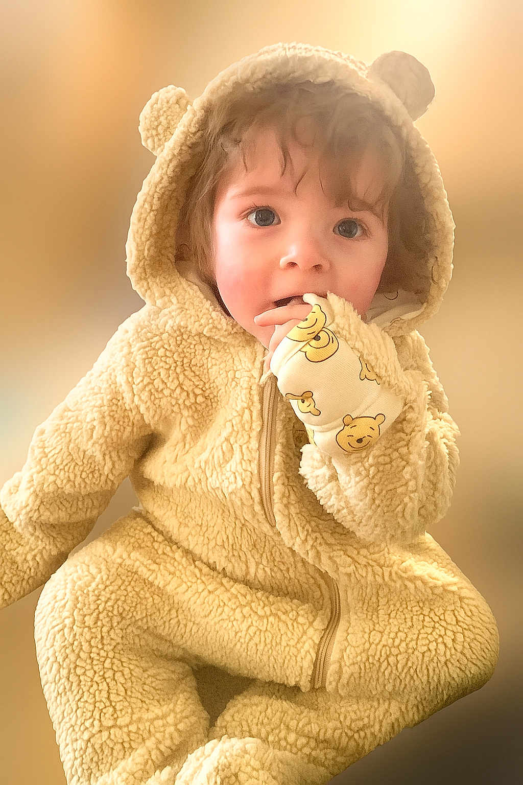 Grayson is registered to the contest to win money with this photo: child, toddler, cute, fluffy, hooded_jumpsuit, bear_ears, mittens, face, blue_eyes, curly_hair, soft_texture, warm_colors, portrait, indoor, baby_clothing, closeup, adorable, young_child, smiling_eyes, cozy