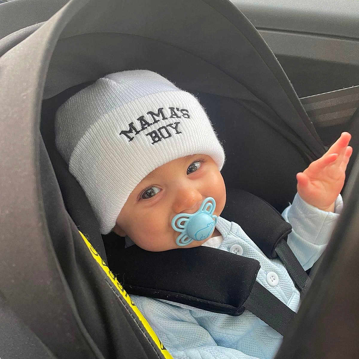 Gabriel participe au concours pour gagner de l'argent avec cette photo : baby, bodypart, bonnet, cap, car, clothing, coat, face, finger, hand, happy, hat, head, jacket, person, photography, portrait, smile, transportation, vehicle