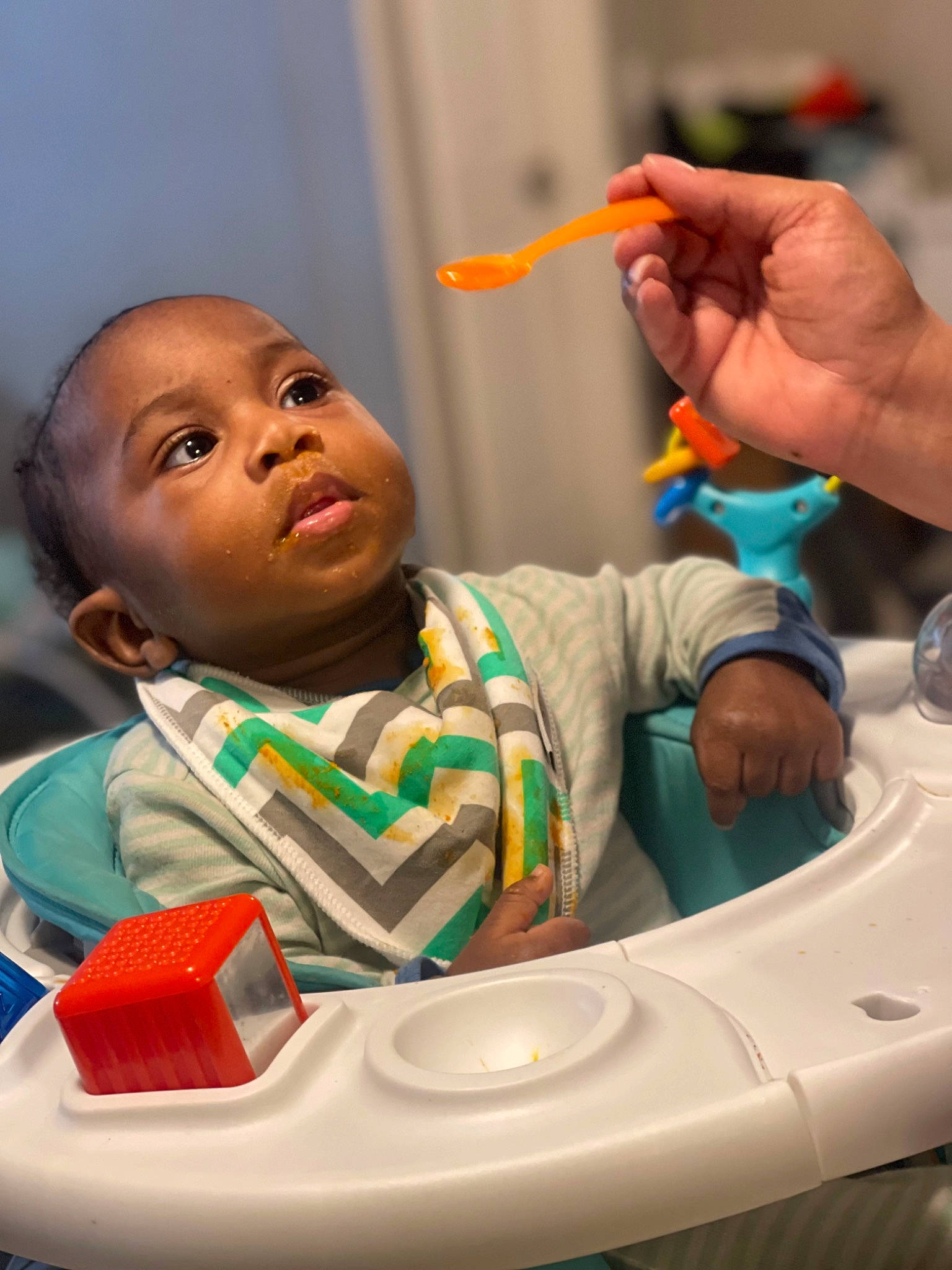 Sylas joined the competition — help win amazing prizes! baby, child, drinkware, eating, finger, food, fun, gesture, hand, happy, leisure, mouth, organ, person, personal_protective_equipment, play, product, room, table, thumb