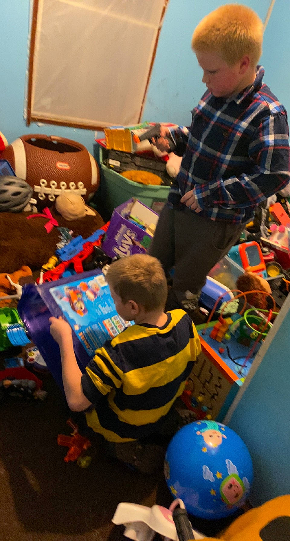 Jermaine is registered to the contest to win money with this photo: arm, blue, child, electronic_device, event, fun, kindergarten, leisure, person, play, recreation, room, sharing, shirt, shoe, sneakers, t_shirt, toddler, toy, world