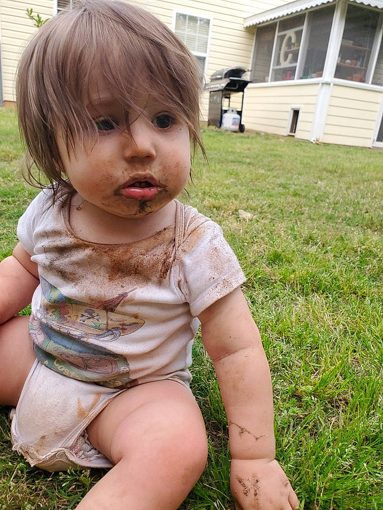Wylder is registered to the contest to win money with this photo: baby_toddler_clothing, building, cheek, dress, grass, hair, happy, head, human_leg, lawn, lip, mouth, nose, person, pink, plant, shorts, skin, thigh, toddler