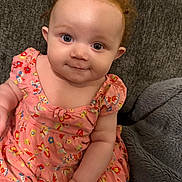 Aniyah is registered to the contest to win money with this photo: baby, blanket, butterflies, child, clothing, couch, curly_hair, cute, eyes, furniture, happy, indoor, infant, person, pink_dress, portrait, sitting, skin, smile, young