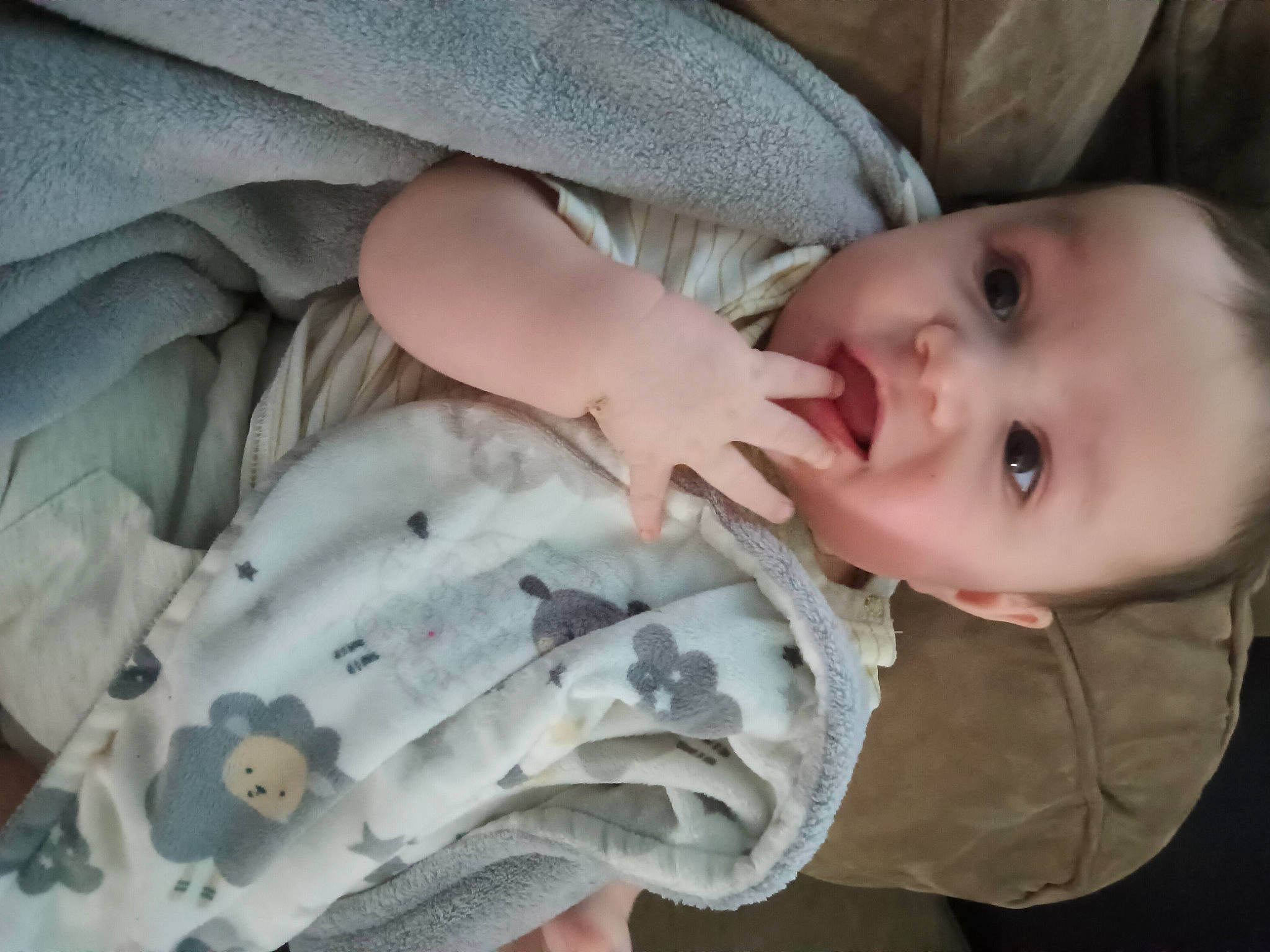 Nathan is registered to the contest to win money with this photo: baby, baby_products, baby_toddler_clothing, cheek, child, comfort, eye, eyelash, gesture, iris, linens, mammal, nail, pattern, person, skin, sleeve, smile, textile, thumb