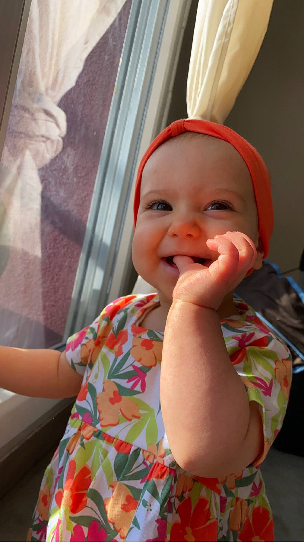 Julya participe au concours pour gagner de l'argent avec cette photo : baby, baby_laughing, baby_toddler_clothing, cheek, curtain, dress, finger, fun, gesture, happy, hat, headwear, joy, lip, nose, person, pink, skin, sleeve, smile