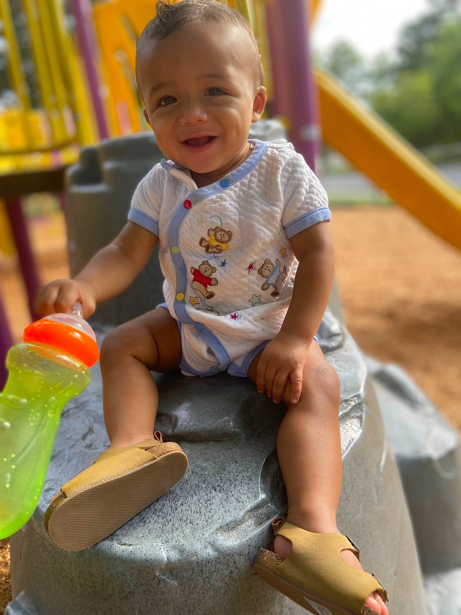 Irish is registered to the contest to win money with this photo: baby_playing_with_toys, baby_toddler_clothing, beauty, child, city, finger, fun, grass, happy, joy, leisure, organ, outdoor_play_equipment, person, playground, recreation, sitting, skin, smile, t_shirt