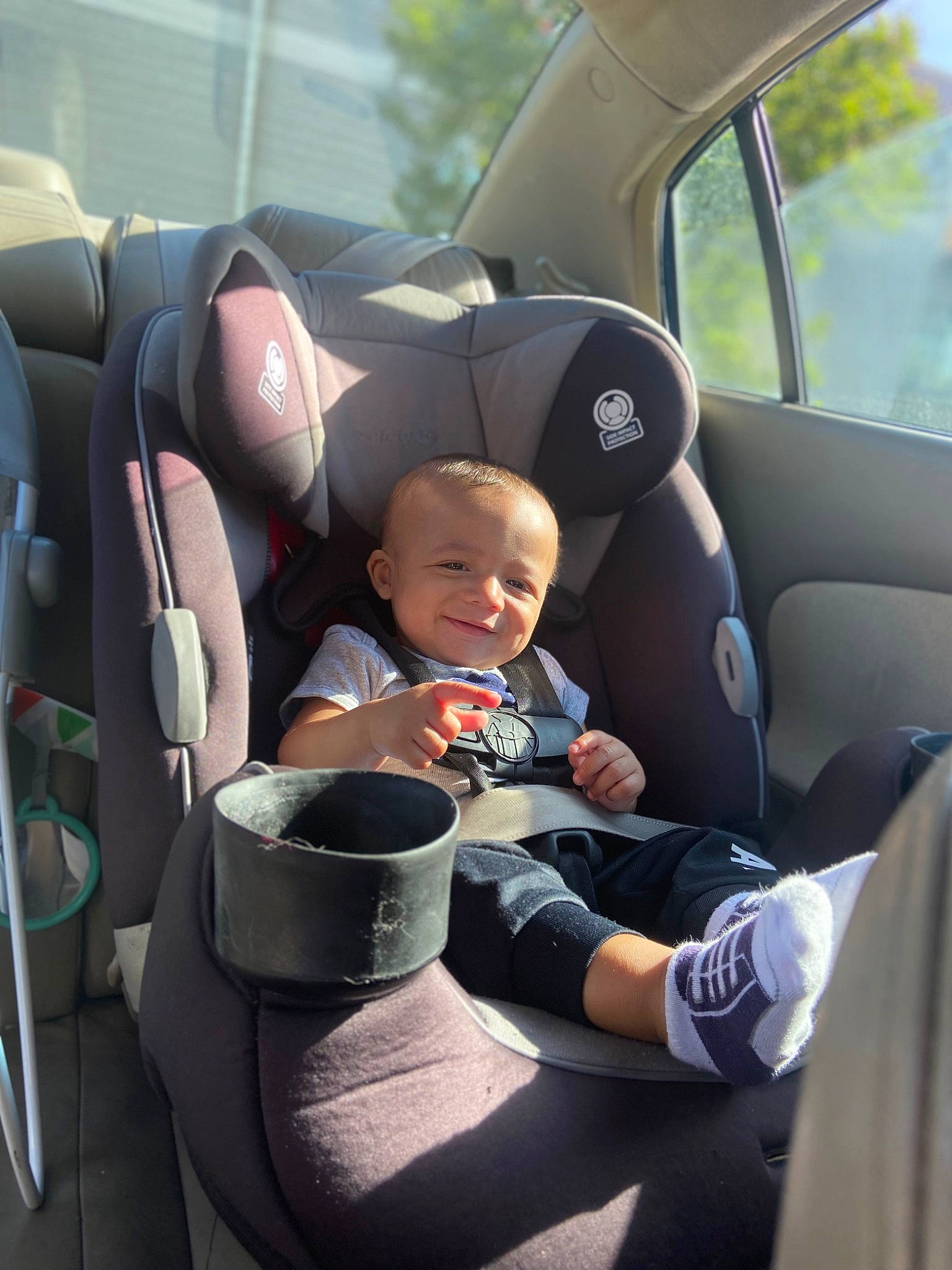Irish is registered to the contest to win money with this photo: auto_part, automotive_design, automotive_exterior, baby_carriage, car, car_seat, car_seat_cover, comfort, head_restraint, joy, mode_of_transport, motor_vehicle, person, plant, product, seat_belt, smile, steering_part, toddler, vehicle