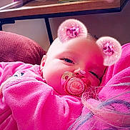 Scarlett-Ann joined the competition — help win amazing prizes! baby, pacifier, pink_clothing, digital_filter, bear_ears, heart_ears, indoor, closeup, child, resting, soft_texture, adult_arm, face, cute, portrait, cozy, smiling, pink_tone, furniture, blanket