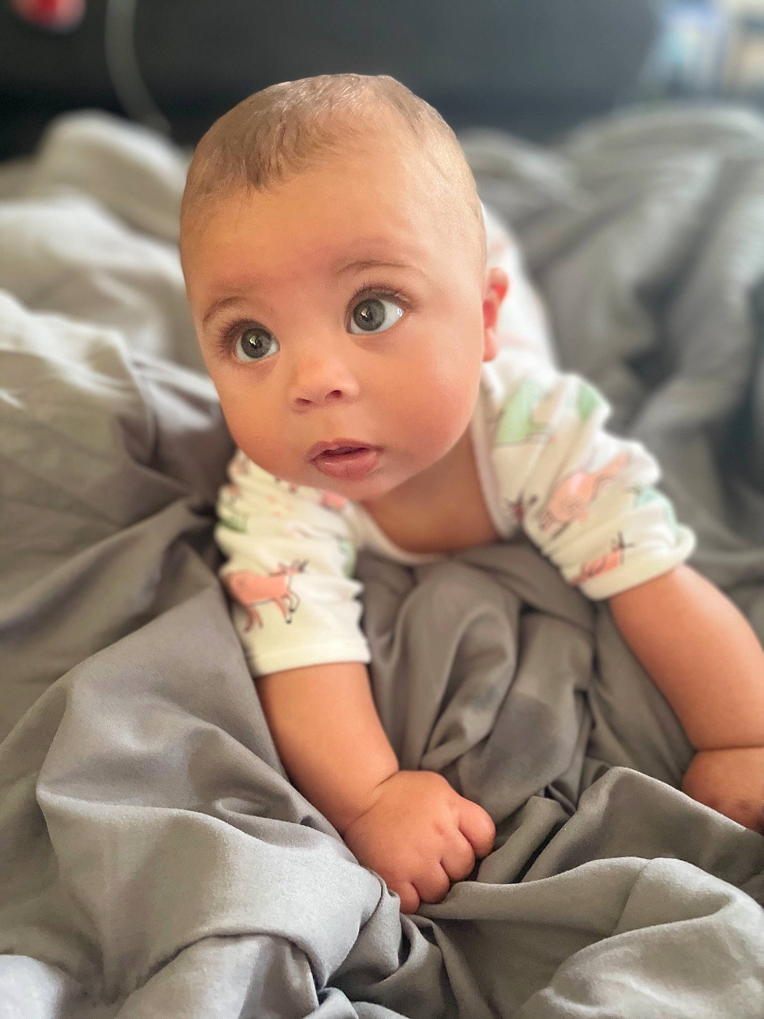 Patience is registered to the contest to win money with this photo: baby, baby_toddler_clothing, cheek, child, close_up, comfort, eye, finger, gesture, iris, lip, mammal, nail, nose, person, sitting, skin, sleeve, surprise, thumb