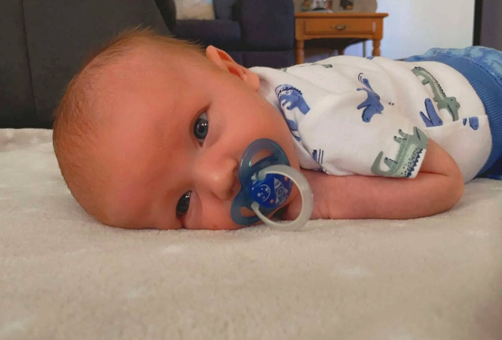 Owen joined the competition — help win amazing prizes! baby, baby_products, baby_toddler_clothing, cheek, child, comfort, couch, drinkware, eyelash, facial_expression, finger, flooring, iris, linens, mouth, nose, person, room, sitting, skin