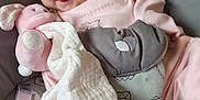 Azzalia is registered to the contest to win money with this photo: baby, baby_seat, blanket, child, comfort, cozy, cushion, cute, fabric, face, head, indoor, infant, patterned, pink_clothing, resting, smiling, soft_toy, stuffed_animal, tongue_out