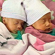 Parthi And Purvi joined the competition — help win amazing prizes! baby, newborn, twins, sleeping, striped_hat, pacifier, blanket, pink, cozy, infant, swaddle, cute, sibling, nap, nursery, bed, soft_texture, peaceful, face, binky