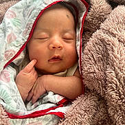 Purvi Manandhar is registered to the contest to win money with this photo: baby, sleeping, blanket, soft, cozy, infant, wrapped, clothing, child, peaceful, face, hand, cute, newborn, comfort, warm, resting, portrait, indoors, babywear