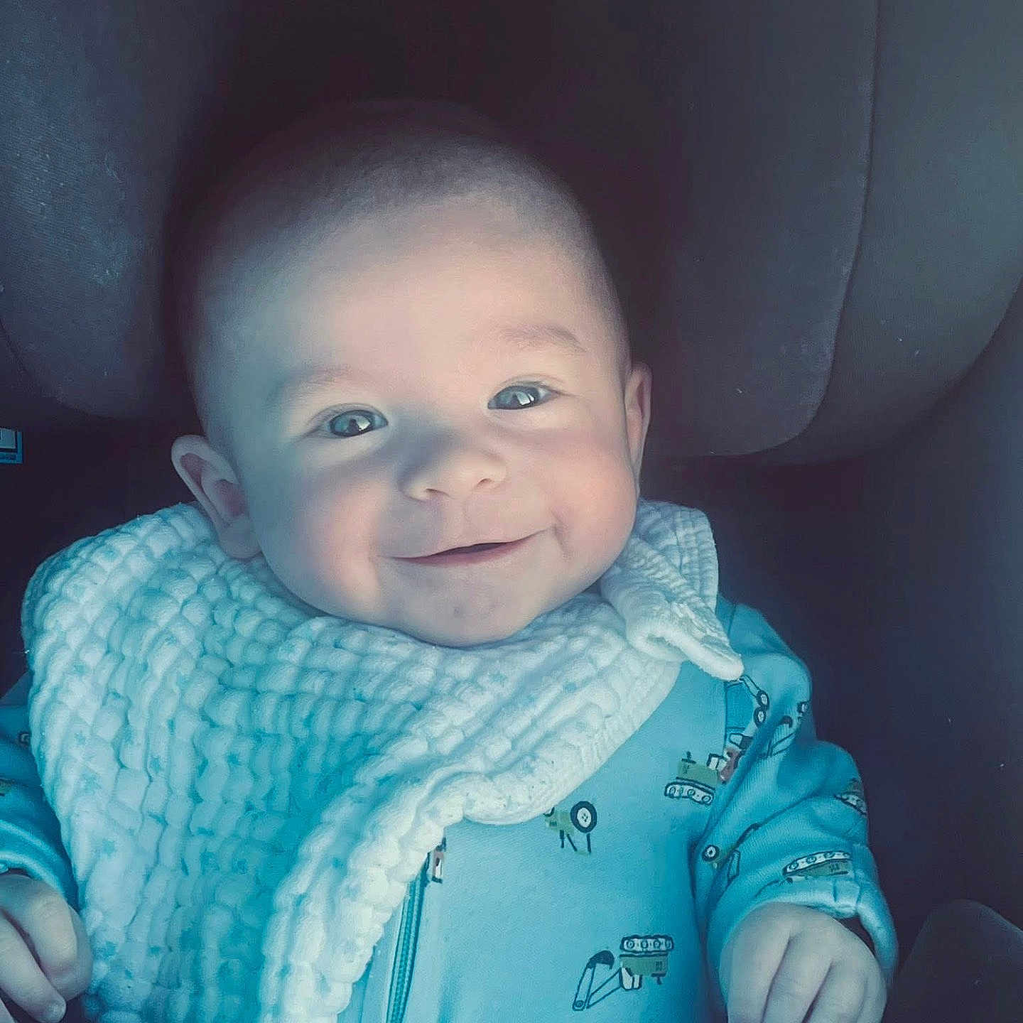 Oliver joined the competition — help win amazing prizes! baby, bib, blue_clothing, car_seat, cheerful, child, closeup, cute, face, hands, happy, head, indoor, infant, onesie, portrait, seatbelt, smiling, soft_lighting, young_child