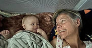 Raeah joined the competition — help win amazing prizes! baby, woman, smile, blanket, face, person, happy, indoor, bed, fabric, texture, blanket_pattern, skin, head, hair, portrait, candid, affection, family, love