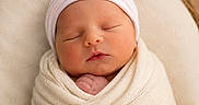 Jagger is registered to the contest to win money with this photo: newborn, baby, swaddled, sleeping, hat, blanket, basket, infant, peaceful, soft, cute, portrait, cozy, closeup, headwear, wrapped, indoors, wooden_floor, resting, child