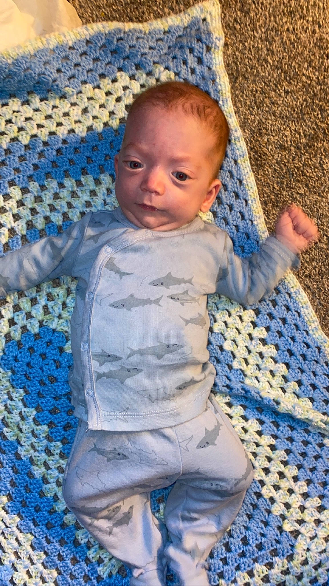 Owen is registered to the contest to win money with this photo: arm, azure, baby, baby_toddler_clothing, blue, child, comfort, electric_blue, fun, happy, head, human_body, linens, nose, pattern, people_in_nature, person, product, skin, textile